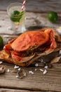 Close-up of cooked crab on the wooden board. Seashells and glass with mojito background. Seafood concept. Healthy meal. Delicious Royalty Free Stock Photo