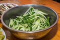 Close-up on cooked vegetables. Southern Chinese festivity rural food on bowls and plates at a wooden table