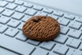 Close-up of a cookie on a computer keyboard. Royalty Free Stock Photo