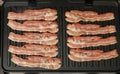 Close up cooking bacon slices on electric grill Royalty Free Stock Photo