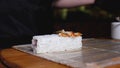 Close-up cooking rice sushi roll. Frame. Close-up of chef of oriental cuisine in gloves preparing sushi rolls. Chef puts Royalty Free Stock Photo