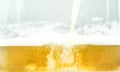 Close up of cool lager beer splash isolated on white background with realistic bubbles