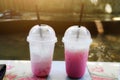 Close-up of cool milk tea in two plastic glasses, the concept of reducing plastic use