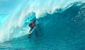 CLOSE UP: Cool surfer dude riding a giant barrel wave on a sunny summer day. Royalty Free Stock Photo