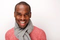 Close up cool young african american male fashion model smiling with scarf against white wall Royalty Free Stock Photo