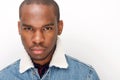 Close up cool young african american male fashion model staring by white wall Royalty Free Stock Photo