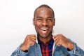 Close up cool young black male fashion model smiling with denim jacket against white background Royalty Free Stock Photo