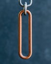 A close-up of a copper chain link.
