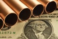 Close up of copper pipes and United States dollar. Royalty Free Stock Photo