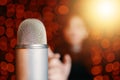 Woman pulls hand to microphone for sing at concert. Royalty Free Stock Photo