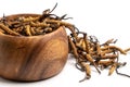 Close up Cordycep sinensis CHONG CAO or mushroom cordyceps on Wooden bowl on isolated background. Medicinal properties in the tr