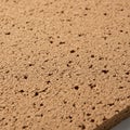 Close-up of a cork board surface displaying its natural, porous texture. The light Royalty Free Stock Photo