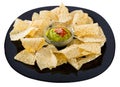 Corn chips nachos with homemade guacamole sauce on black plate Royalty Free Stock Photo
