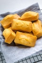 Close-up of corn muffins on plate with bowl of corn meal and additional muffins in the background Royalty Free Stock Photo