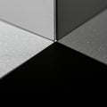 Close-up of the corner of a metallic cube casting a sharp shadow on a textured Royalty Free Stock Photo