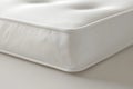 Close-up of a corner of a white mattress, highlighting the stitching and fabric texture Royalty Free Stock Photo