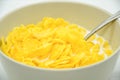 Close-up of cornflakes with milk-soaked in deep bowl with spoon Royalty Free Stock Photo