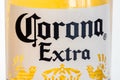Close-up for Corona Extra logo on the bottle. Corona Extra is pale lager produced by Cerveceria Modelo in Mexico