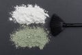 Close-up of a cosmetic dry white and green clay powder on gray background with mask brush