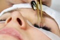 Close-up of a cosmetic procedure for gluing eyelashes by a cosmetologist.