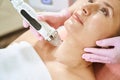 Close up of cosmetologist doing microneedle rf lifting of neck skin of woman