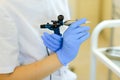 Close up cosmetologist hands keeping microblading device at beauty salon.