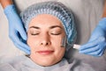 Beautician massaging woman forehead with facial massager. Royalty Free Stock Photo