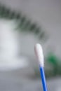 Close-up of a cotton swab, a macro photo of a cotton swab, blue cotton swabs, cotton pads for skin cleansing, a gray towel, a Royalty Free Stock Photo