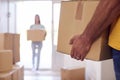 Close Up Of Couple Carrying Boxes Through Front Door Of New Home On Moving Day Royalty Free Stock Photo