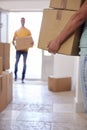 Close Up Of Couple Carrying Boxes Through Front Door Of New Home On Moving Day Royalty Free Stock Photo