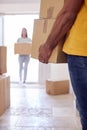 Close Up Of Couple Carrying Boxes Through Front Door Of New Home On Moving Day Royalty Free Stock Photo