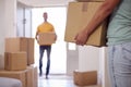 Close Up Of Couple Carrying Boxes Through Front Door Of New Home On Moving Day Royalty Free Stock Photo