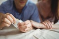 Close-up of couple with a condom on bed Royalty Free Stock Photo