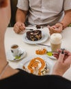 Close up of couple eating swiss roll cake and coffee