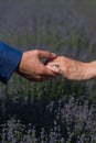 Close up of couple hands with engagement ring