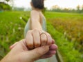 Close up couple hands man holding happy fiance hand with diamond engagement ring on her finger after wedding proposal at tropical Royalty Free Stock Photo