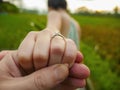 Close up couple hands man holding happy fiance hand with diamond engagement ring on her finger after wedding proposal at tropical Royalty Free Stock Photo