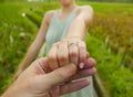 Close up couple hands man holding happy fiance hand with diamond engagement ring on her finger after wedding proposal at tropical Royalty Free Stock Photo