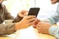 Close up of couple hands using a smart phone Royalty Free Stock Photo