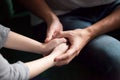 Close up of couple holding hands, giving psychological support c Royalty Free Stock Photo