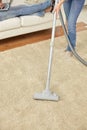 Close up of couple legs and vacuum cleaner at home Royalty Free Stock Photo