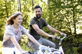 Close up of couple riding bikes in nature