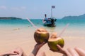 Close-up Of Couple`s Hand Holding Coconut With Drinking Straw In Front Of Idyllic Royalty Free Stock Photo