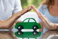 Couple Protecting Green Wooden Car Royalty Free Stock Photo