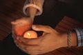 Close up of couple`s hands cupped around a burning candle. Hands of young man and woman that protect the flame of a candle. Love Royalty Free Stock Photo