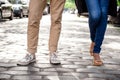 Close up of couple's legs in keds standing at street. Royalty Free Stock Photo