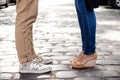 Close up of couple's legs in keds standing at street. Royalty Free Stock Photo