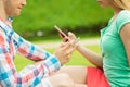 Close up of couple with smartphones outdoors