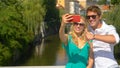 CLOSE UP: Couple taking selfies and shooting videos while exploring Ljubljana.