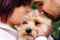 Close-up of a couple of young boys with their puppy giving them a kiss. concept of family, humans and dogs, animal care Royalty Free Stock Photo